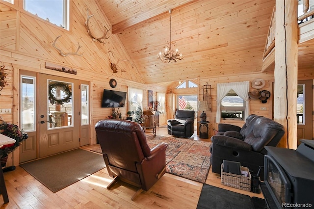 living room with a healthy amount of sunlight, light hardwood / wood-style flooring, high vaulted ceiling, and wood ceiling