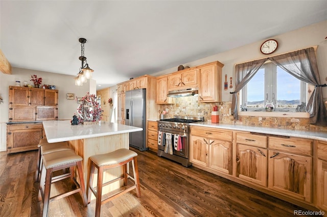 kitchen featuring pendant lighting, backsplash, dark wood-type flooring, a kitchen island, and stainless steel appliances