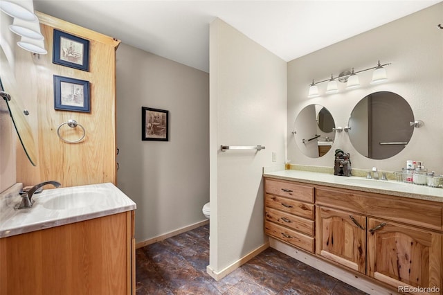 bathroom featuring vanity and toilet