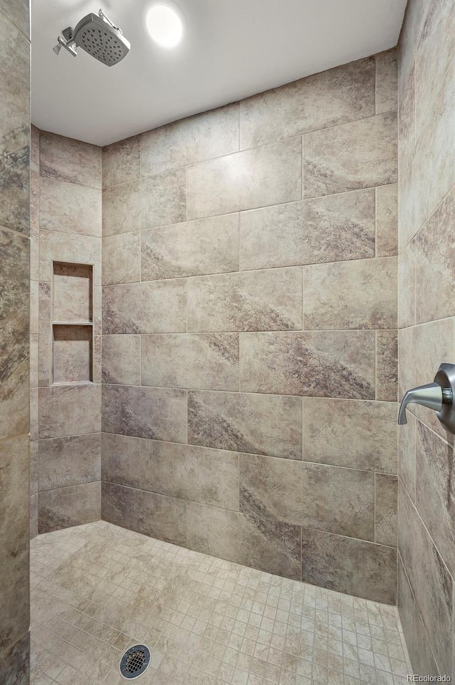 bathroom with a tile shower