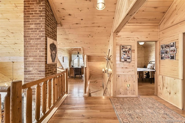 hall featuring hardwood / wood-style floors, high vaulted ceiling, wooden walls, and wood ceiling