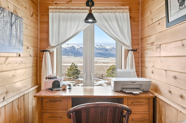 office space featuring a mountain view and wood walls