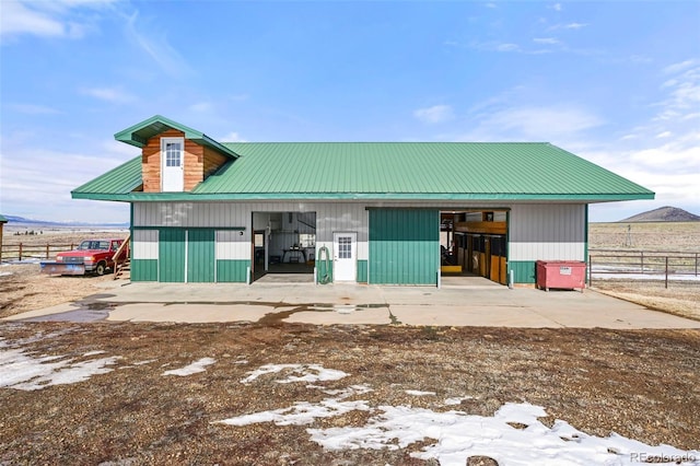 rear view of property with an outbuilding