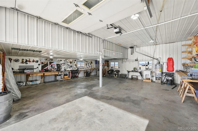 garage featuring a workshop area, gas water heater, and a garage door opener