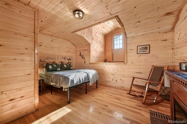 bedroom featuring wooden walls, wooden ceiling, and light hardwood / wood-style floors