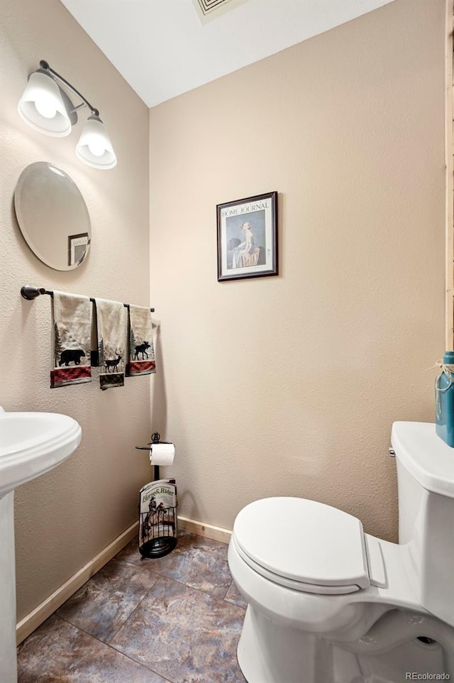 29 Howe Rd, Westcliffe, CO 81252 - half bathroom featuring toilet and stone finish flooring