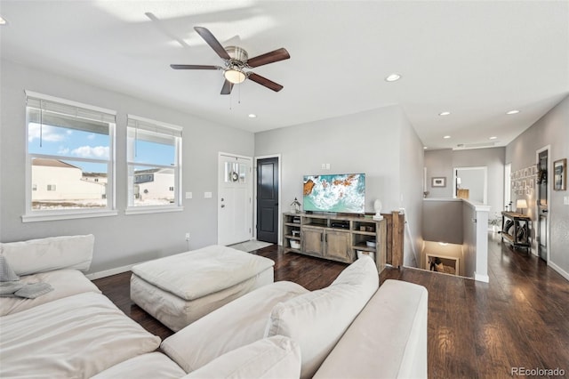 living room with ceiling fan and dark hardwood / wood-style flooring