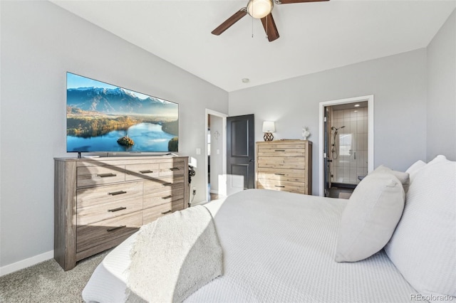 carpeted bedroom with ensuite bath and ceiling fan