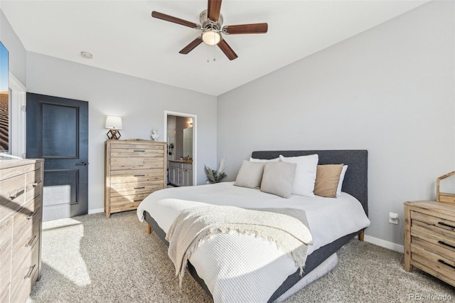 bedroom featuring ensuite bathroom, ceiling fan, and light colored carpet