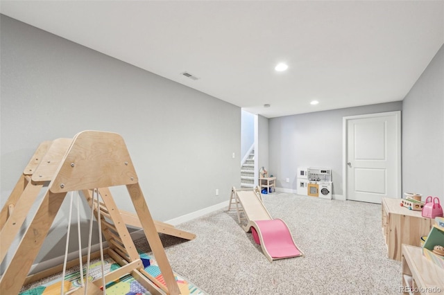 game room with light colored carpet