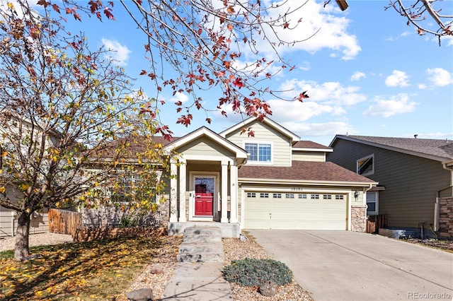 view of front facade with driveway, a shingled roof, and stone siding