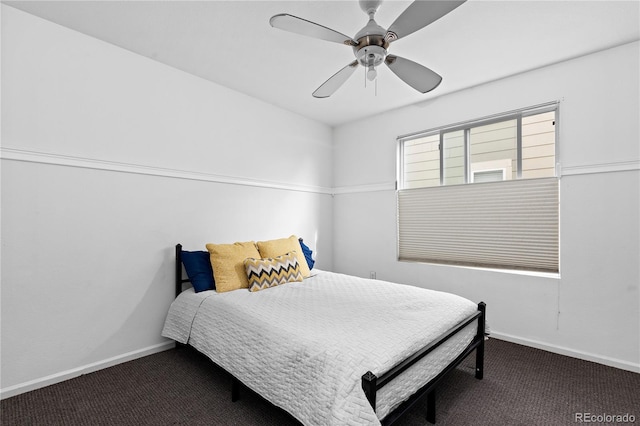 carpeted bedroom featuring baseboards and a ceiling fan
