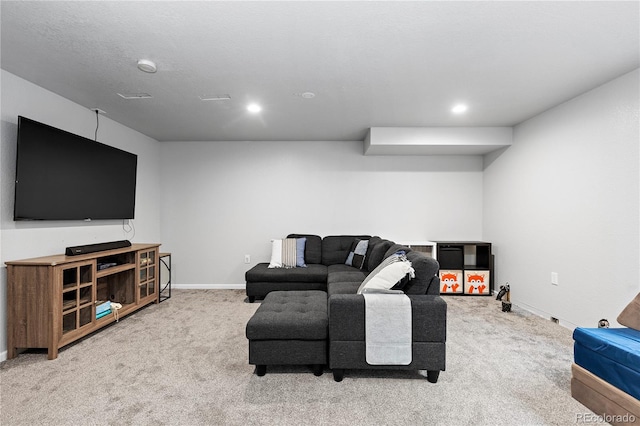 carpeted living area featuring baseboards and recessed lighting
