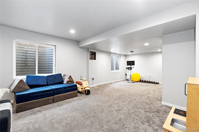 carpeted living room featuring baseboards and recessed lighting