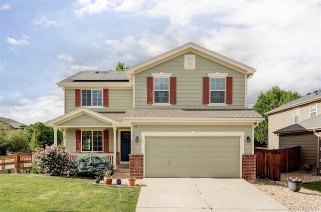 6385 S Nelson Way, Littleton, CO 80127 - view of front of house featuring an attached garage, concrete driveway, solar panels, brick siding, and a porch