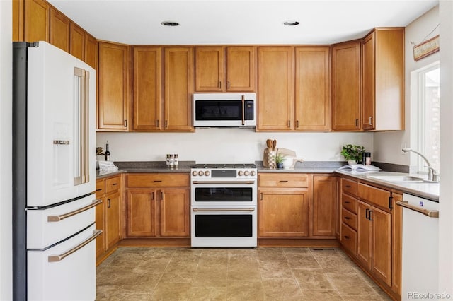 6385 S Nelson Way, Littleton, CO 80127 - kitchen with white appliances, brown cabinets, and recessed lighting