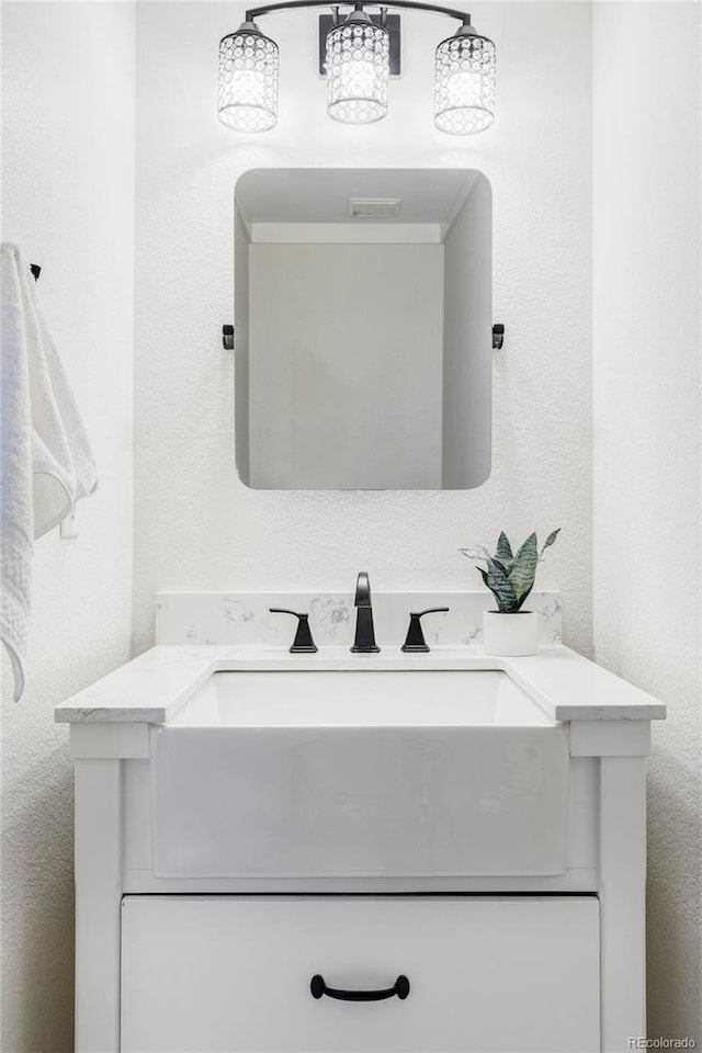 6385 S Nelson Way, Littleton, CO 80127 - bathroom with vanity and a textured wall