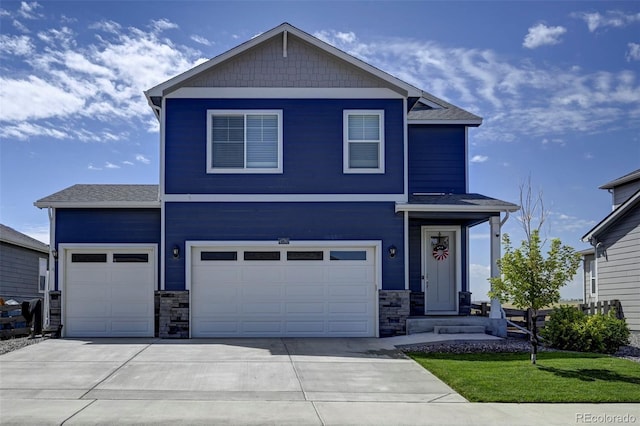 view of front of home featuring stone siding, driveway, and an attached garage