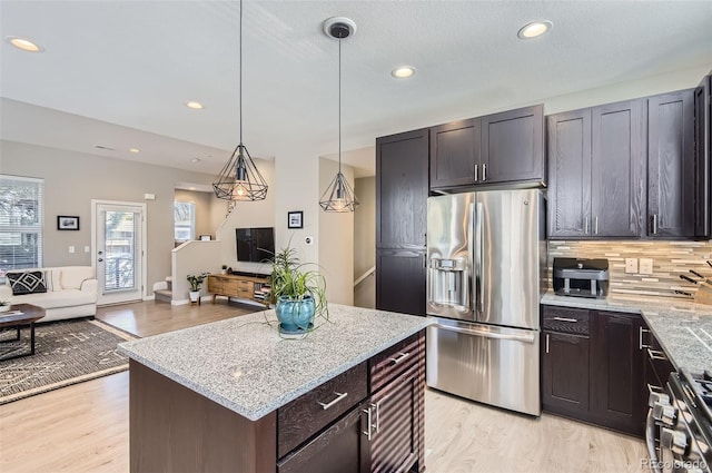 3795 Depew St Unit D, Wheat Ridge, CO 80212 - kitchen featuring appliances with stainless steel finishes, healthy amount of natural light, decorative backsplash, open floor plan, and recessed lighting