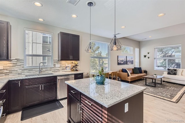 3795 Depew St Unit D, Wheat Ridge, CO 80212 - kitchen featuring dishwasher, light wood-style floors, open floor plan, light stone counters, and recessed lighting