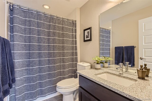 3795 Depew St Unit D, Wheat Ridge, CO 80212 - full bathroom featuring vanity and a textured wall