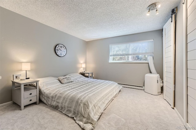 bedroom featuring a baseboard radiator, light colored carpet, a textured ceiling, and a barn door