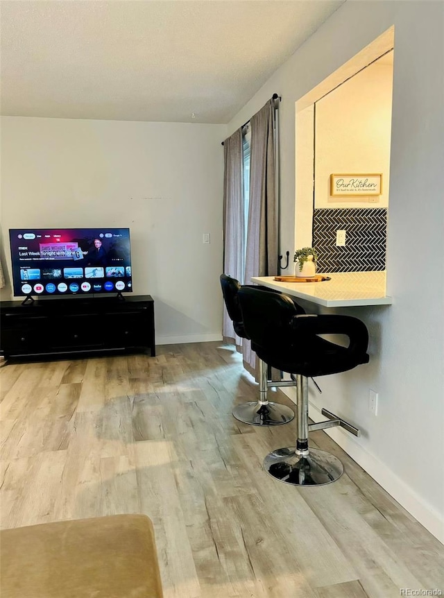 office space featuring baseboards and wood finished floors