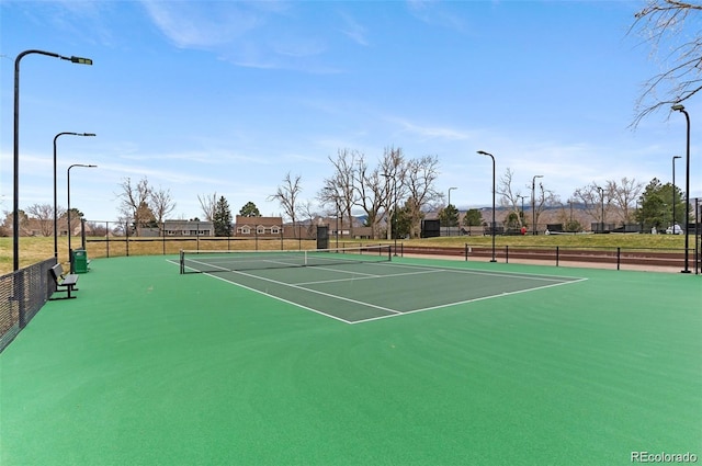 view of sport court featuring fence