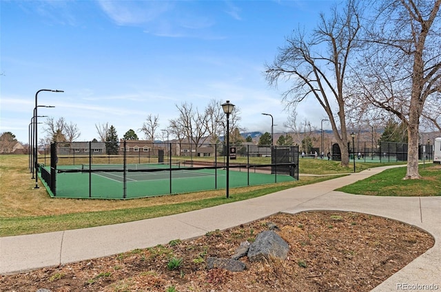 view of tennis court featuring fence