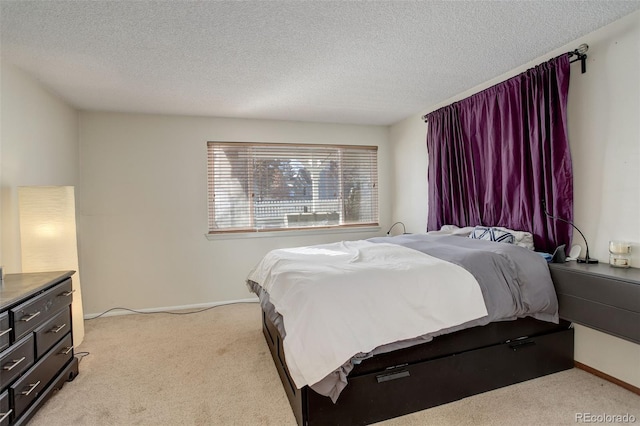 bedroom with a textured ceiling, baseboards, and light carpet