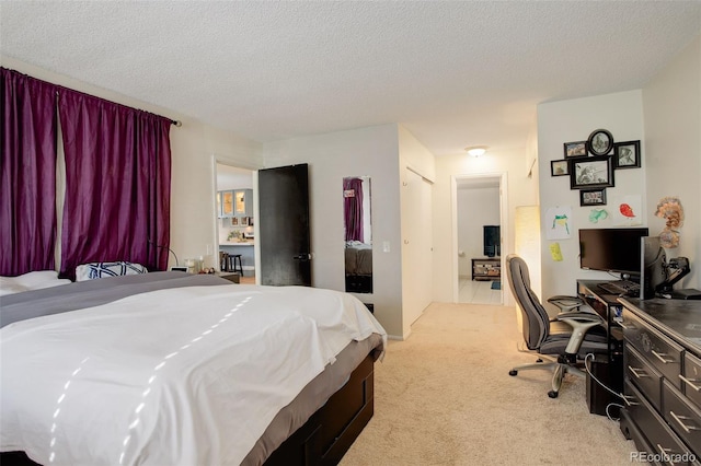 bedroom featuring light carpet and a textured ceiling