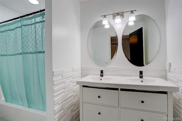 bathroom with a sink, shower / bath combo, and double vanity