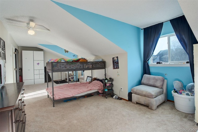 carpeted bedroom with a textured ceiling, a ceiling fan, baseboards, and vaulted ceiling