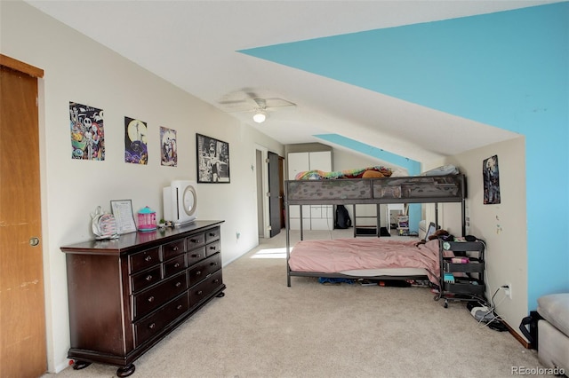 carpeted bedroom with a ceiling fan and vaulted ceiling