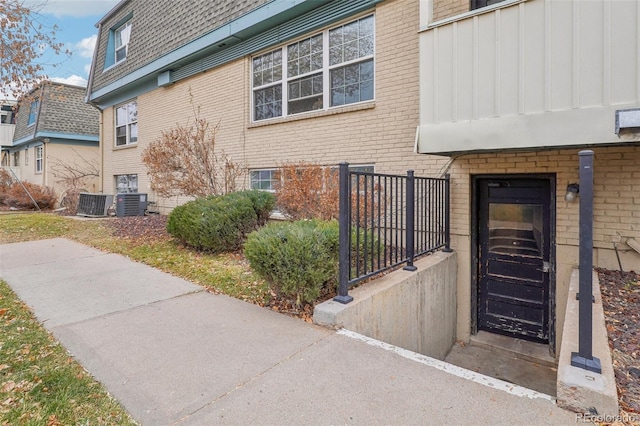 doorway to property featuring central air condition unit