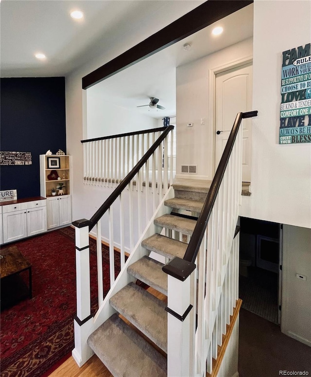 stairs with ceiling fan, wood finished floors, and recessed lighting