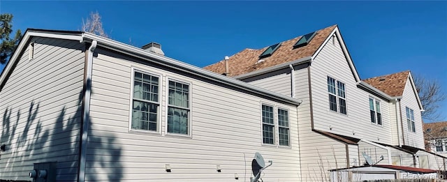 view of home's exterior with a chimney