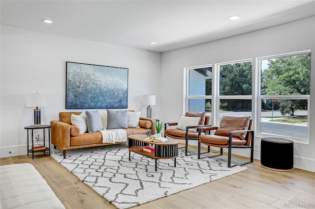 living room featuring a wealth of natural light, recessed lighting, and wood finished floors