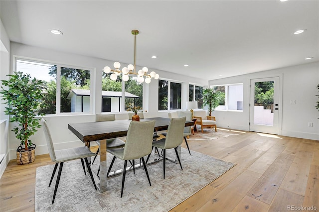 dining area featuring an inviting chandelier and light wood-type flooring