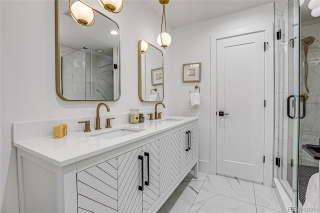 bathroom with a shower with door and vanity