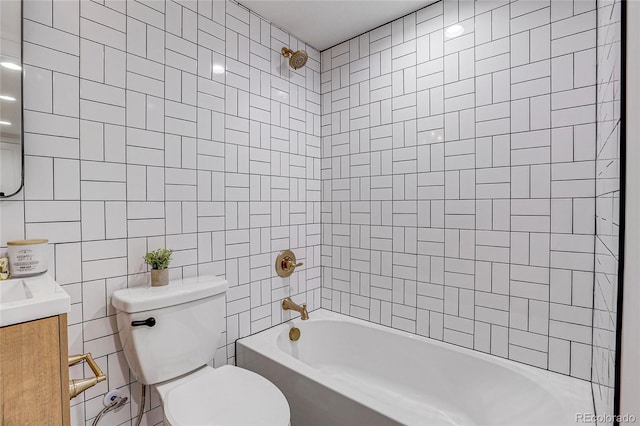 full bathroom with tile walls, tiled shower / bath combo, toilet, and vanity