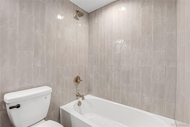 bathroom featuring shower / washtub combination and toilet