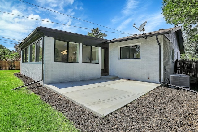 rear view of house with central AC unit and a patio area