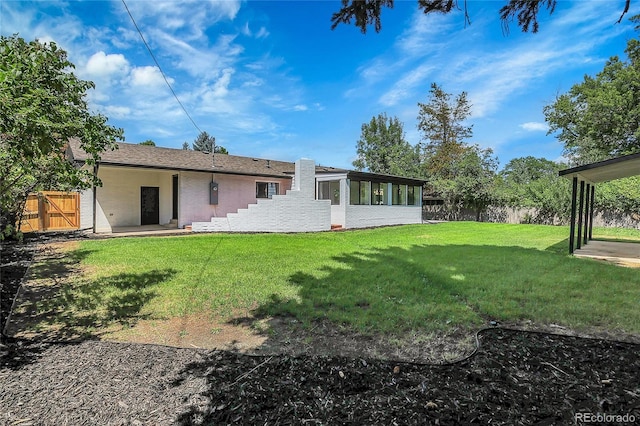 rear view of house with a yard