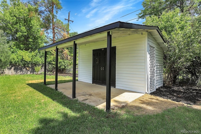 view of outbuilding featuring a yard