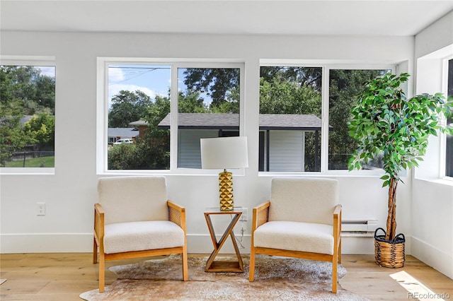 sunroom / solarium with a baseboard heating unit