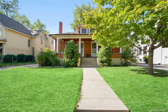 view of front of home featuring covered porch and a front yard