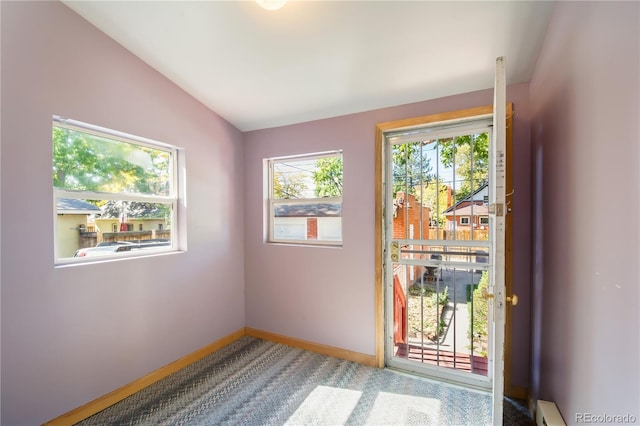 entryway featuring carpet floors and vaulted ceiling