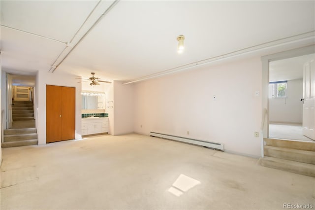 unfurnished living room featuring ceiling fan, baseboard heating, and light colored carpet