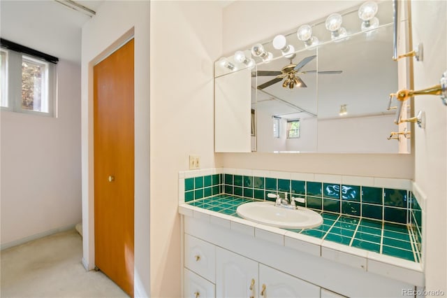 bathroom featuring ceiling fan, backsplash, and vanity